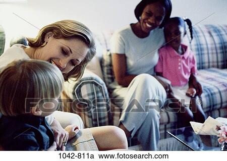 Stock Image - multiethnic, attentive, people, smiling, talking, listening, sitting. Fotosearch