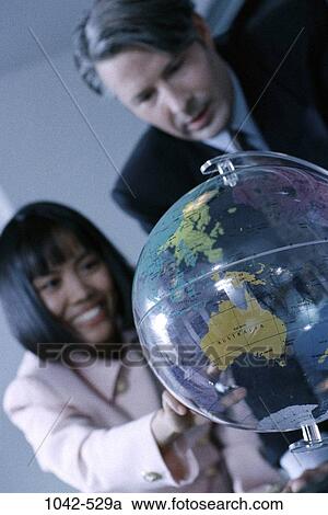 Stock Image - multiethnic, business, Middle-aged, executives, global, meetings, indoors. Fotosearch