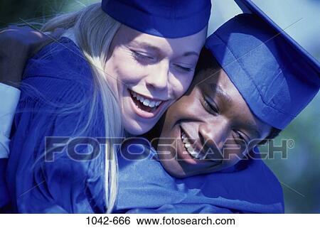 Stock Photograph - multiethnic, people, couple, outdoors, achievement, hugging. Fotosearch
