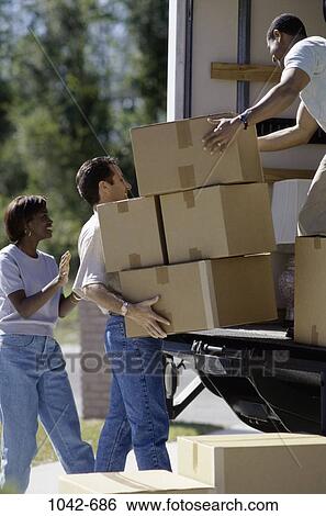 Stock Photograph - multiethnic, people, home, moving, outdoors, carrying, friends. Fotosearch