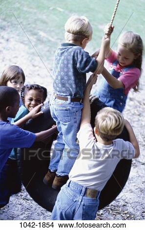 multiethnic, people, rope, playing, friendship, swinging, swing View Large Photo Image Picture - multiethnic, people, rope, playing, friendship, swinging, swing. Fotosearch