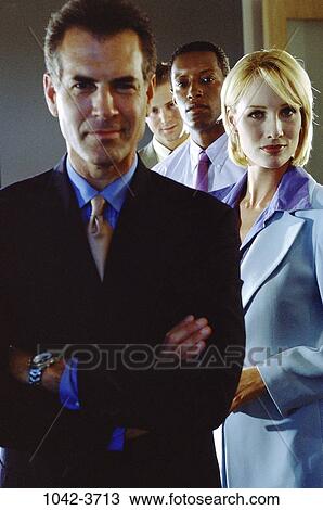 multiethnic, staring, coworkers, standing, business, looking, serious View Large Photo Image Stock Image - multiethnic, staring, coworkers, standing, business, looking, serious. Fotosearch
