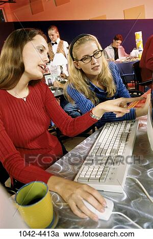 Stock Image - multiethnic, women, people, technology, computer, pointing, cafe. Fotosearch