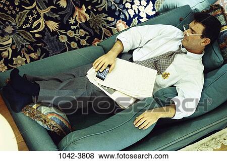 overhead, people, newspaper, sleeping, eyeglasses, couch View Large Photo Image Stock Photo - overhead, people, newspaper, sleeping, eyeglasses, couch. Fotosearch