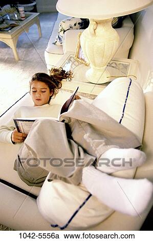 Stock Image - overhead, people, reading, couch, book, girl, child. Fotosearch