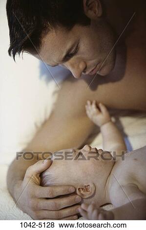 people, baby, crying, calm, family, angry, comforting View Large Photo Image Stock Photo - people, baby, crying, calm, family, angry, comforting. Fotosearch