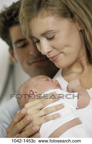 Stock Image - people, baby, family, infant, parents, Caucasian, Parents baby outdoors. Fotosearch