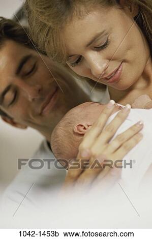 Stock Image - people, baby, family, parents, Parents baby outdoors. Fotosearch