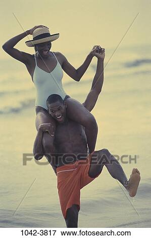 Stock Photo - people, balance, hands, water, playing, hat, couple. Fotosearch
