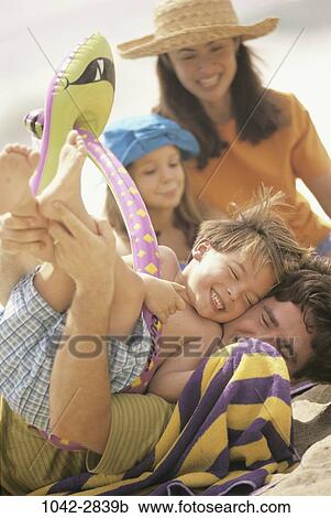 Stock Image - people, beach, family, parents, Families recreation water. Fotosearch