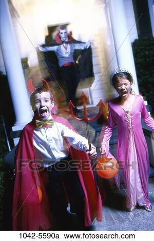 Stock Image - people, blur, fear, outdoors, costumes, Halloween, devil. Fotosearch