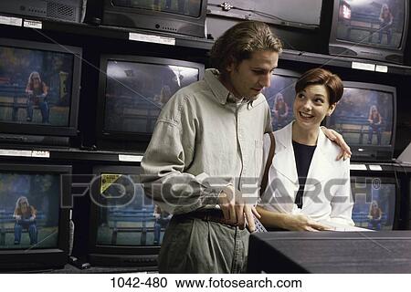 Stock Image - people, couple, choices, shopping, picking, store. Fotosearch
