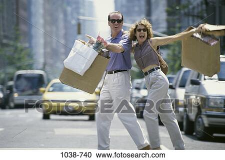 Stock Image - people, couple, crossing, street, outdoors, shopping. Fotosearch