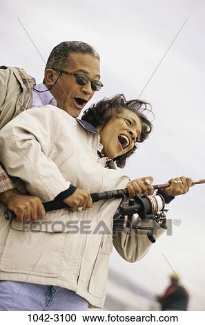 people, couple, excitement, excited, catching, holding, outdoors View Large Photo Image Stock Image - people, couple, excitement, excited, catching, holding, outdoors. Fotosearch