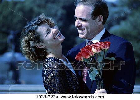 Stock Image - people, couple, flowers, lifestyles, outdoors, Middle-aged, roses. Fotosearch