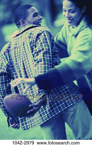 people, couple, football, outdoors, sports, African-American, Young couples recreation View Large Photo Image Stock Photo - people, couple, football, outdoors, sports, African-American, Young couples recreation. Fotosearch