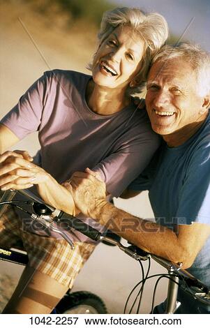 people, couple, senior, bicycle, laughing, riding, leaning View Large Photo Image Stock Photo - people, couple, senior, bicycle, laughing, riding, leaning. Fotosearch