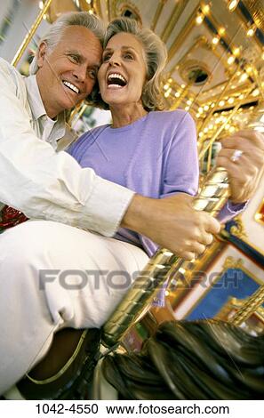 people, couple, senior, laughing, riding, outdoors, amusement View Large Photo Image Stock Image - people, couple, senior, laughing, riding, outdoors, amusement. Fotosearch