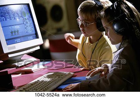 Stock Image - people, desk, keyboard, monitor, playing, table, computer. Fotosearch