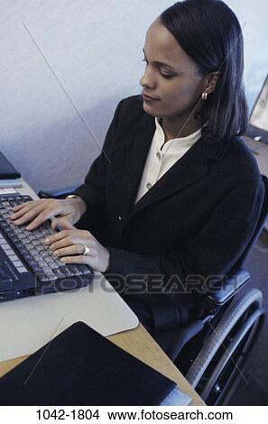 people, desk, keyboard, sitting, typing, individual, wheelchair View Large Photo Image Picture - people, desk, keyboard, sitting, typing, individual, wheelchair. Fotosearch
