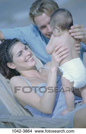 people, diaper, baby, holding, standing, outdoors, family View Large Photo Image Picture - people, diaper, baby, holding, standing, outdoors, family. Fotosearch