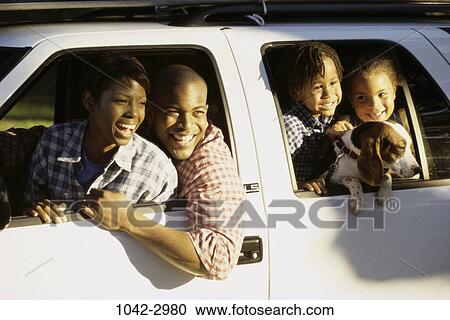 Stock Image - people, dog, car, pet, outdoors, family. Fotosearch