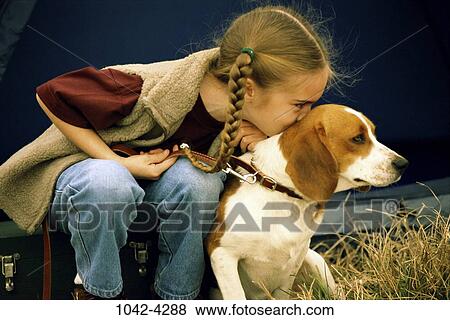 Stock Photo - people, dog, pet, girl, leaning, outdoors, child. Fotosearch