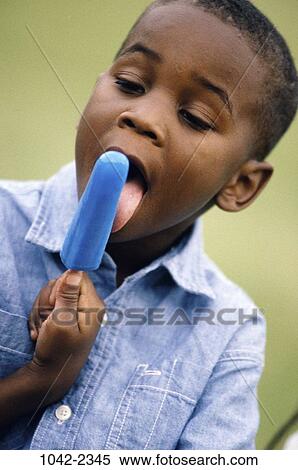 Stock Photography - people, eating, boy, summer, outdoors, desserts, food. Fotosearch