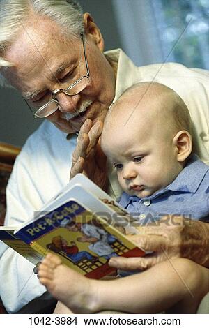 people, eyeglasses, baby, reading, book, holding, family View Large Photo Image Picture - people, eyeglasses, baby, reading, book, holding, family. Fotosearch