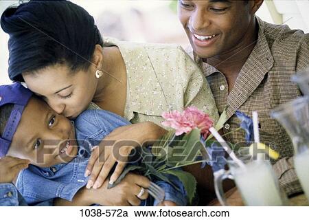 people, glass, smiling, sitting, laughing, flower, outdoors View Large Photo Image Stock Image - people, glass, smiling, sitting, laughing, flower, outdoors. Fotosearch