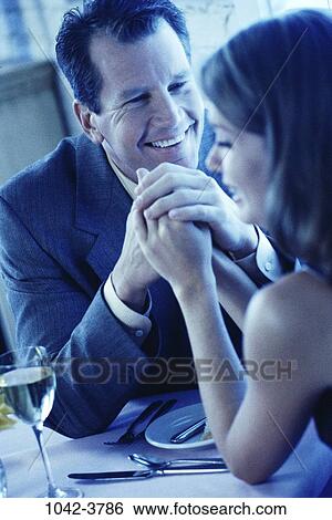 people, hands, smiling, table, couple, holding, romantic View Large Photo Image Stock Photograph - people, hands, smiling, table, couple, holding, romantic. Fotosearch
