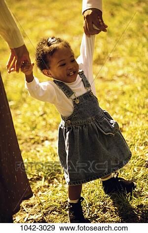 Stock Photo - people, hands, toddler, holding, girl, outdoors, nurturing. Fotosearch