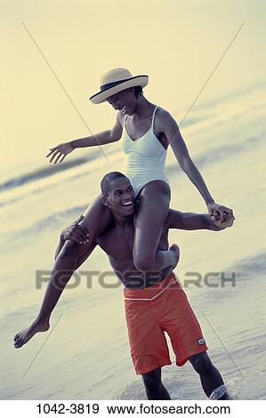 people, hat, couple, beach, laughing, playful, adventurous View Large Photo Image Stock Photo - people, hat, couple, beach, laughing, playful, adventurous. Fotosearch
