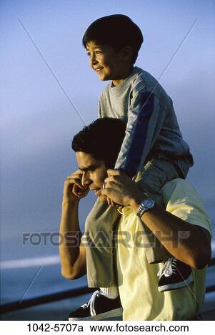 Stock Image - people, Hispanic, beach, tranquility, carrying, commitment, family. Fotosearch
