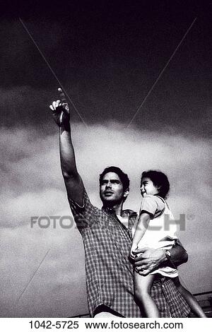 people, Hispanic, holding, pointing, outdoors, point, family View Large Photo Image Stock Photography - people, Hispanic, holding, pointing, outdoors, point, family. Fotosearch