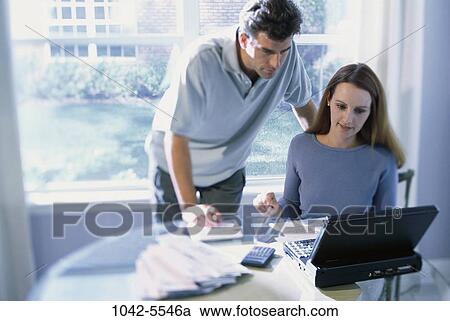 people, home, calculator, couple, papers, computer, laptop View Large Photo Image Stock Image - people, home, calculator, couple, papers, computer, laptop. Fotosearch