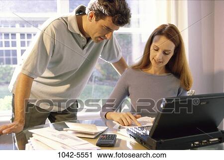people, home, calculator, couple, papers, computer, laptop View Large Photo Image Stock Image - people, home, calculator, couple, papers, computer, laptop. Fotosearch