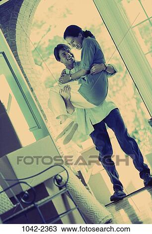 people, home, smiling, moving, couple, laughing, tradition View Large Photo Image Stock Image - people, home, smiling, moving, couple, laughing, tradition. Fotosearch
