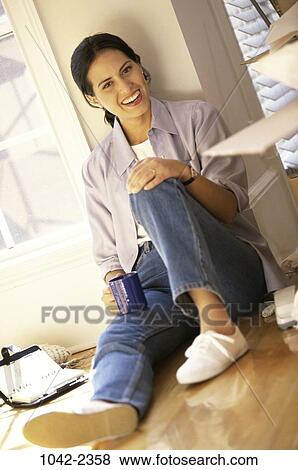 people, home, woman, smiling, moving, sitting, drinking View Large Photo Image Stock Photo - people, home, woman, smiling, moving, sitting, drinking. Fotosearch