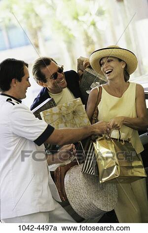 Stock Image - people, hotel, couple, hospitality, outdoors, Middle-aged, bags. Fotosearch