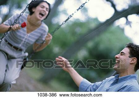 people, laughing, rose, swing, couples outdoors, energetic, joyous View Large Photo Image Stock Photograph - people, laughing, rose, swing, couples outdoors, energetic, joyous. Fotosearch