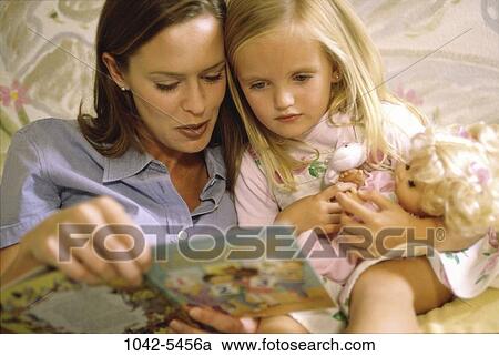 Stock Image - people, listening, mother, reading, book, doll, nurturing. Fotosearch