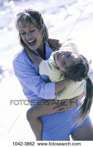 people, mother, beach, laughing, holding, playful, nurturing View Large Photo Image Stock Image - people, mother, beach, laughing, holding, playful, nurturing. Fotosearch
