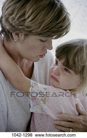Stock Photo - people, mother, crying, holding, family, comforting, sad. Fotosearch