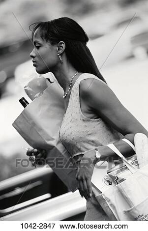 people, paper, woman, walking, earring, watch, outdoors View Large Photo Image Stock Photo - people, paper, woman, walking, earring, watch, outdoors. Fotosearch