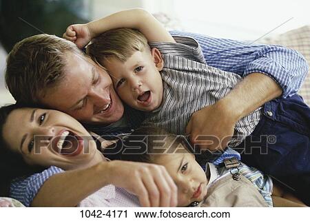people, playing, laughing, playful, hugging, family View Large Photo Image Stock Image - people, playing, laughing, playful, hugging, family. Fotosearch