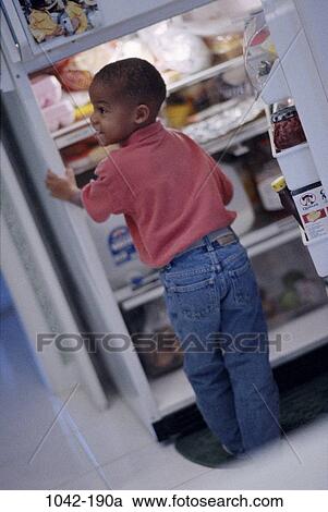 Stock Image - people, refrigerator, boy, snack, food, hungry, indoors. Fotosearch