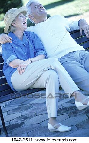 people, relaxation, hat, couple, bench, sitting View Large Photo Image Stock Image - people, relaxation, hat, couple, bench, sitting. Fotosearch