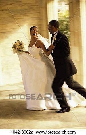 Stock Image - people, running, celebration, couple, laughing, motion, outdoors. Fotosearch