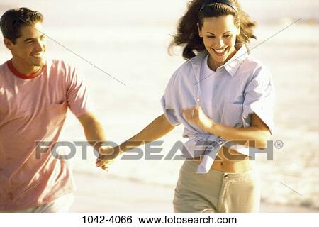 people, running, couple, beach, playful, Middle-aged, joyous View Large Photo Image Stock Photograph - people, running, couple, beach, playful, Middle-aged, joyous. Fotosearch